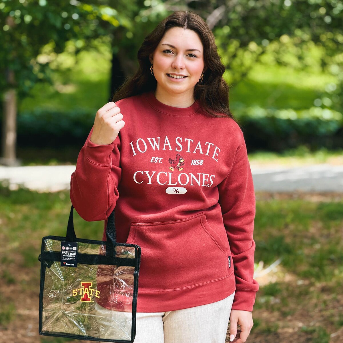Student holding I-State Clear Tote with Black Handles